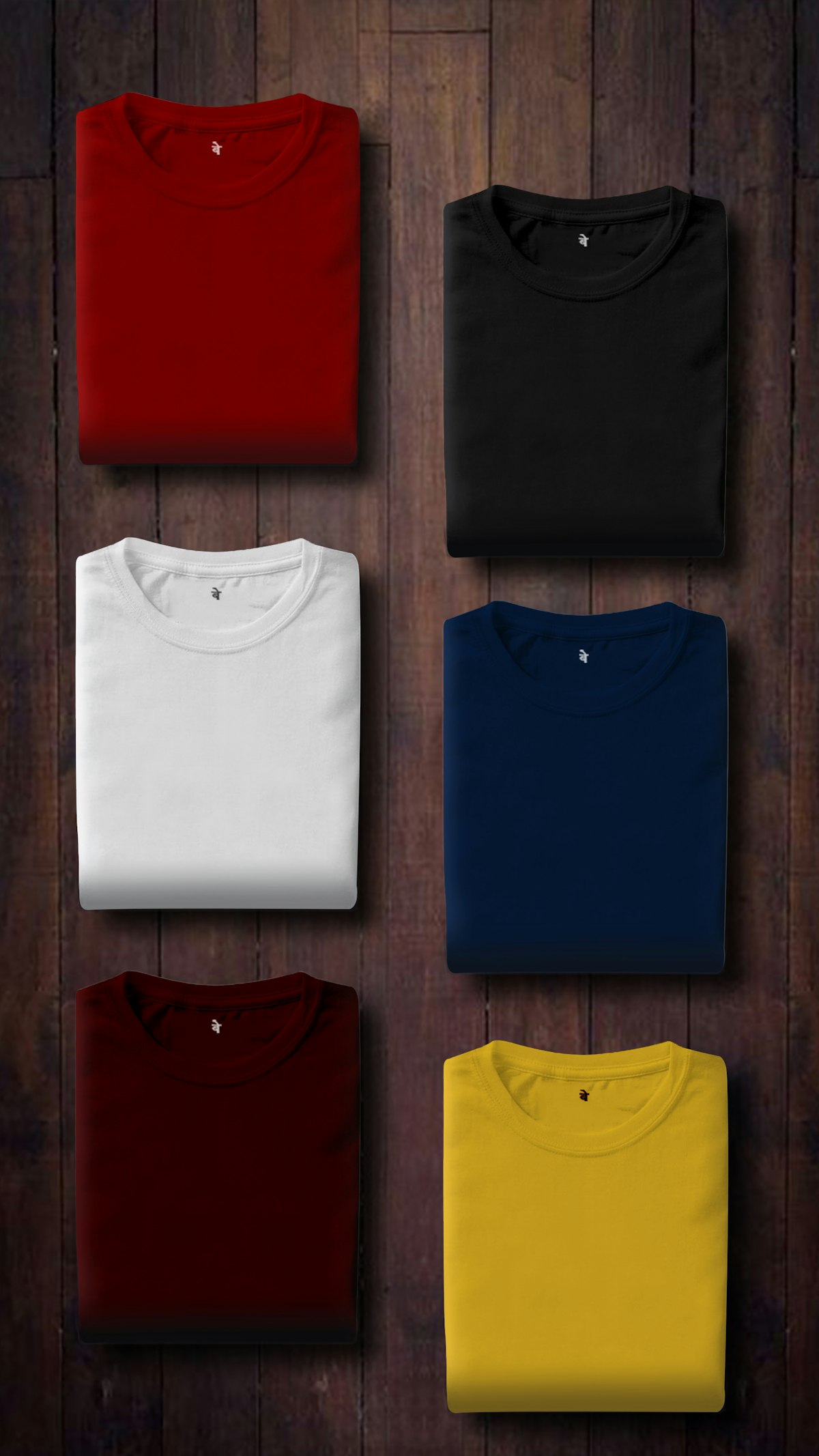 Seis malhas dobradas em vermelho, preto, branco, marinho, vinho e amarelo, como cartela de cor